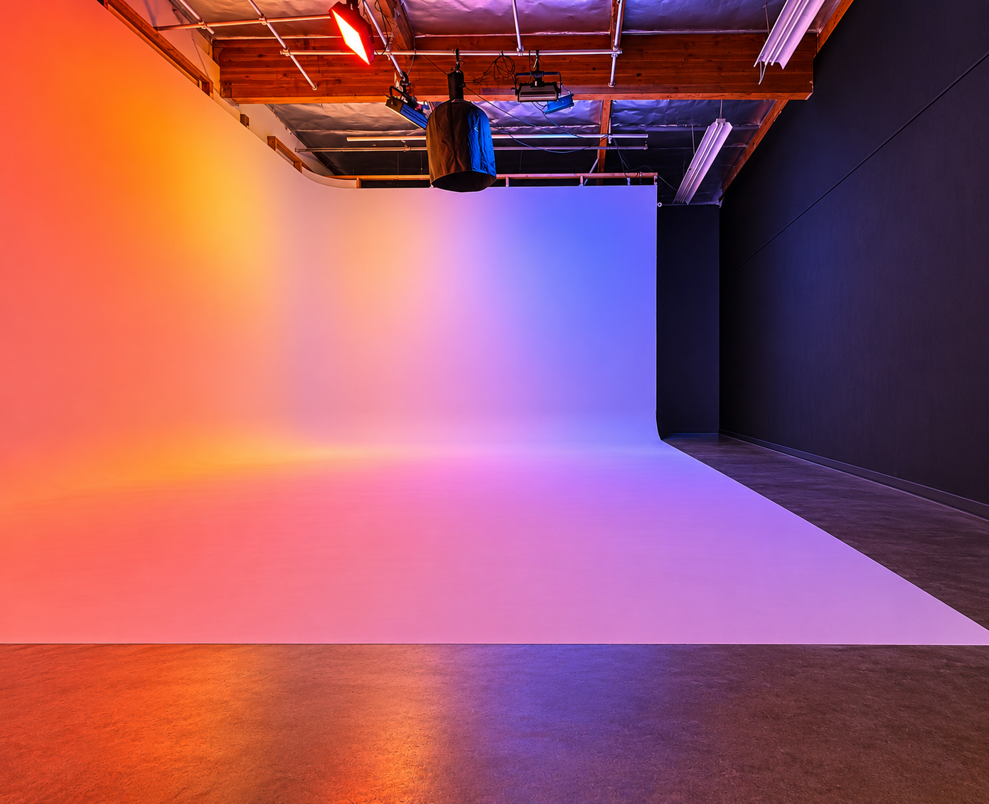 Empty cyclorama with orange, pink and blue RGB lighting